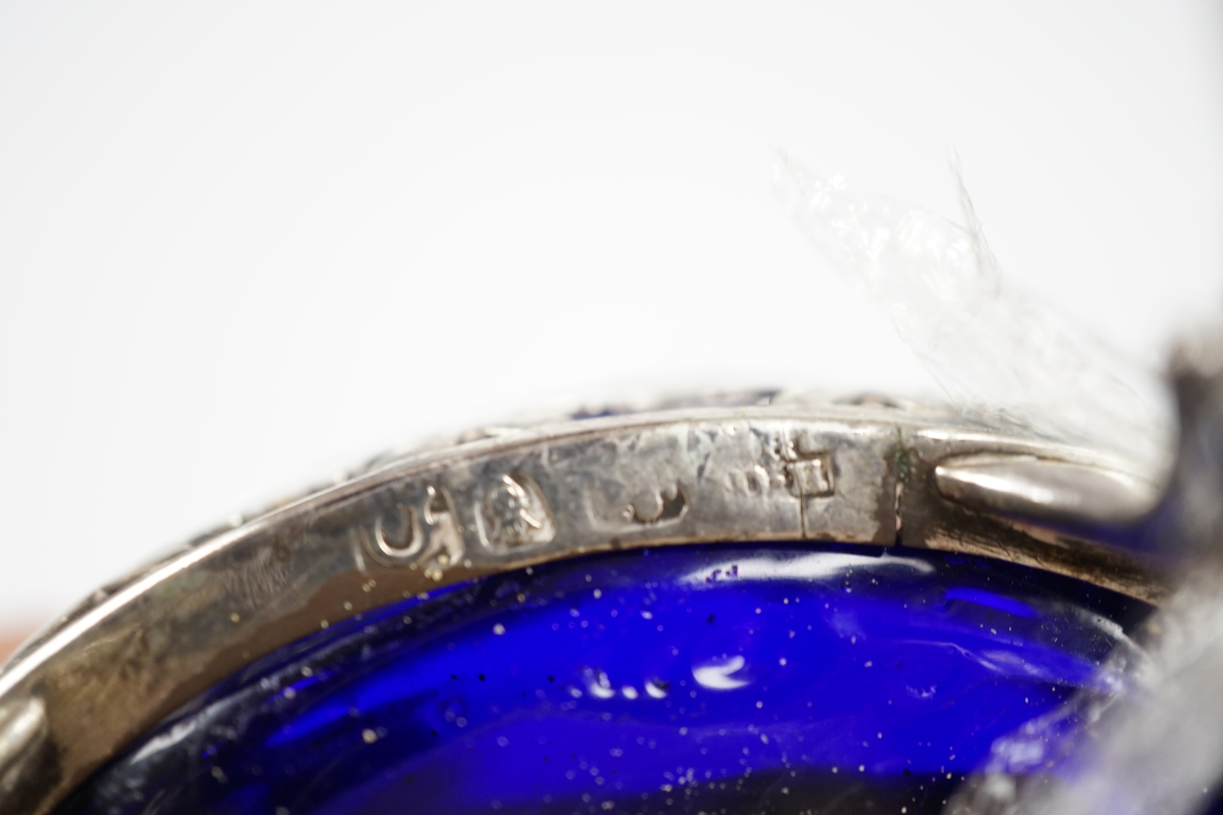 A pair of late George II pierced silver oval salts, by Robert & David Hennell I, London, 1759, with associated blue glass liners, 83mm. Condition - poor